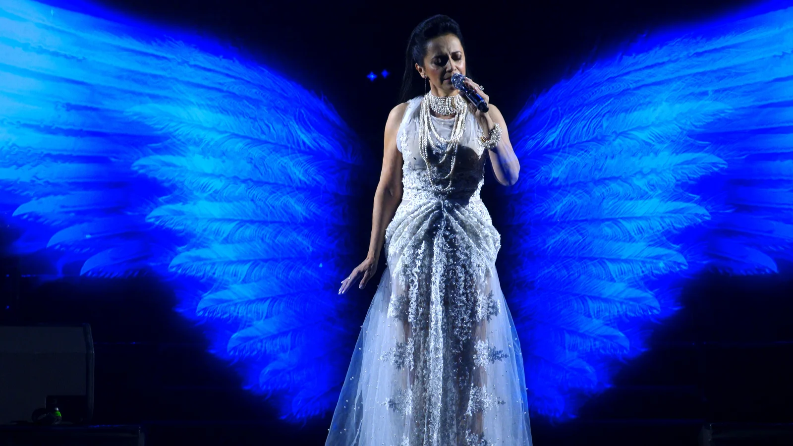 Close-up of Lucie Bílá with holographic wings — Lucie Bílá Christmas gala concert, SCREENRENTAL.EU